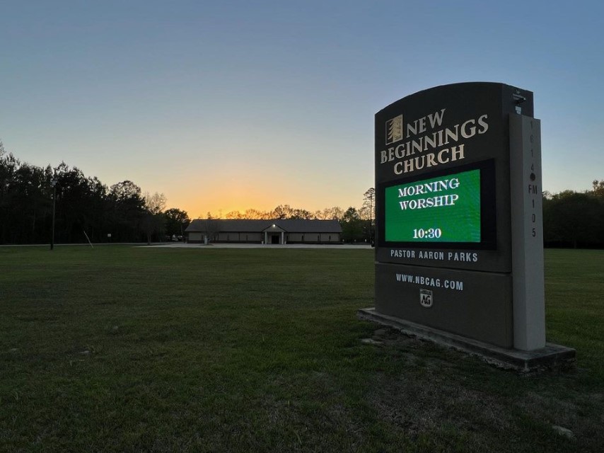 New Beginnings Church sign with church in background